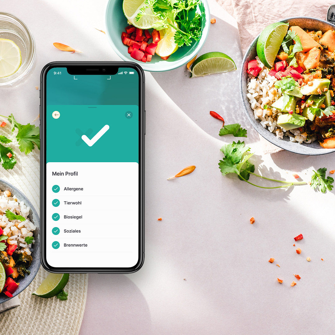 Bild von Schüsseln voller leckerem Essen und Handy mit der SoVi-App daneben